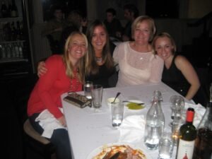 Mom and daughters enjoying a lovely Christmas dinner in Canonsburg, PA seated at a white linen table